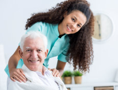 lady caregiver and old man smiling