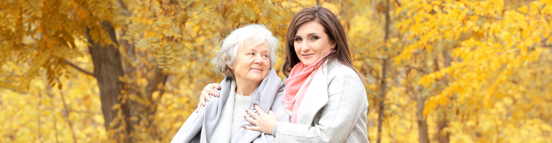 lady caregiver with senior woman smiling